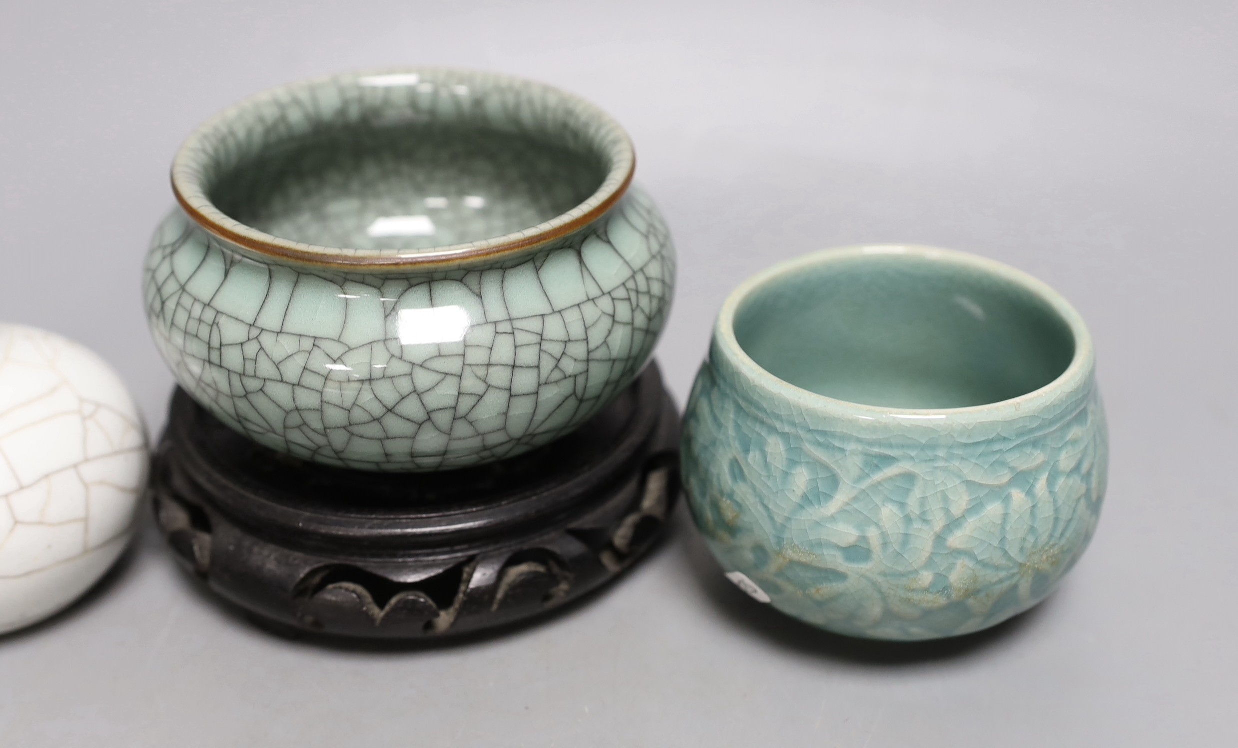 Three Chinese crackle glaze vessels, a Korean celadon pot and a hardwood stand